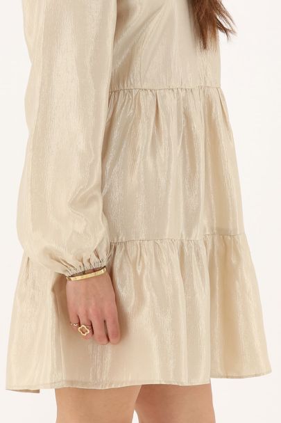 Beige glanzende jurk met ruffles