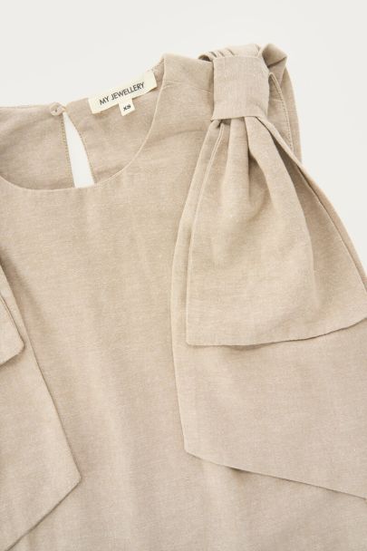 Beige top with bow details