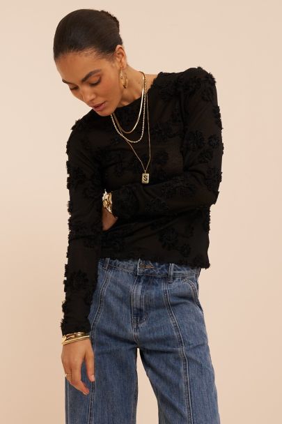 Black top with long sleeves and embroidered flowers