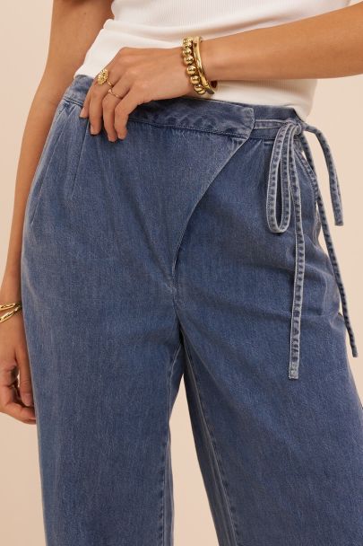 Blue wide leg jeans with wrap and bow detail