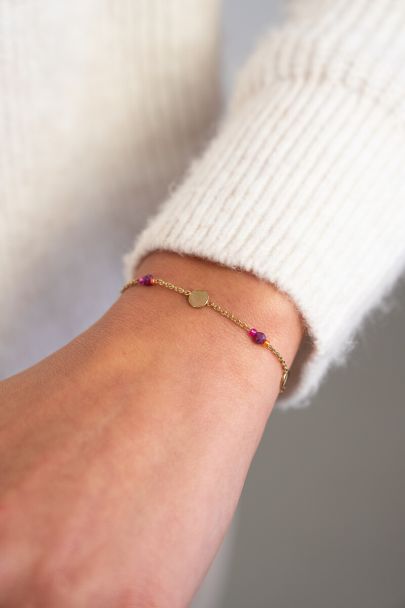 Armband met munt en paarse kralen