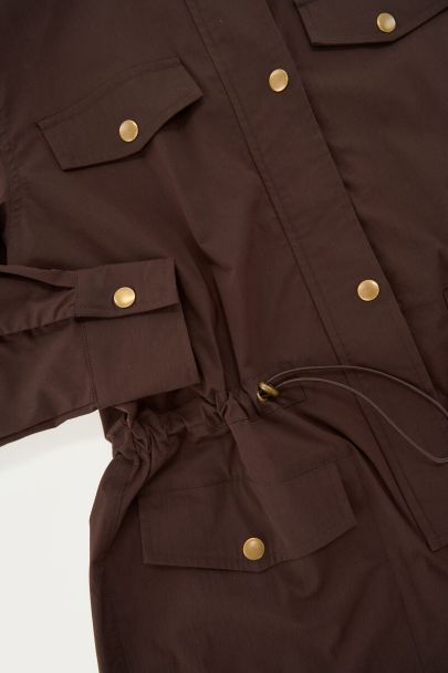 Donkerbruine playsuit met goudkleurige knopen