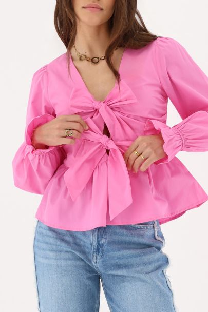 Top rose avec nœuds et péplum