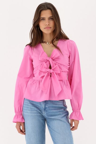 Top rose avec nœuds et péplum