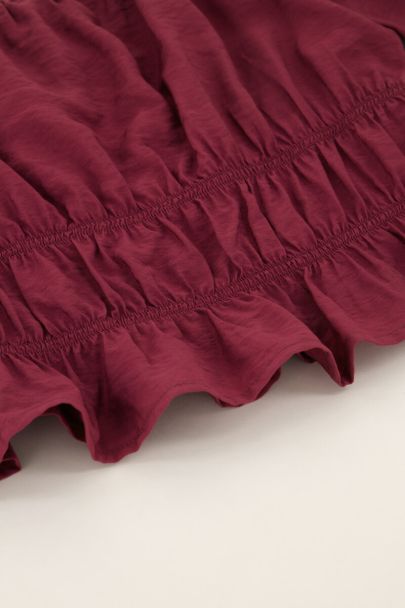 Paarse off shoulder top met ruffles