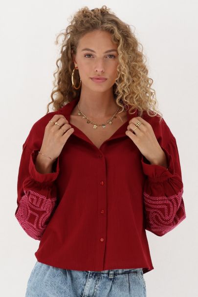 Red blouse with pink embroidery details