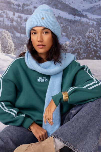 Light blue knitted scarf with fringe