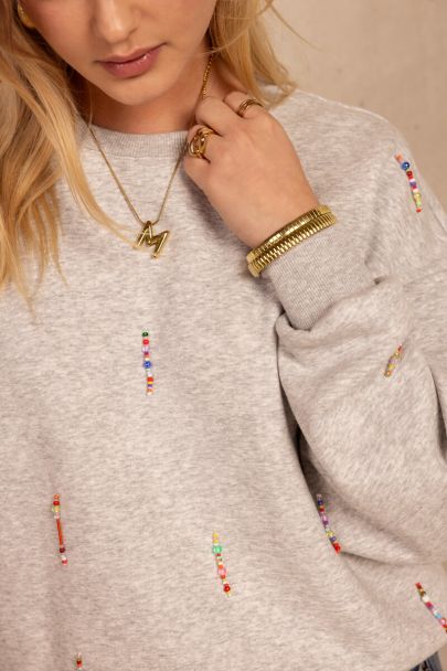 Light grey sweater with coloured beaded fringes