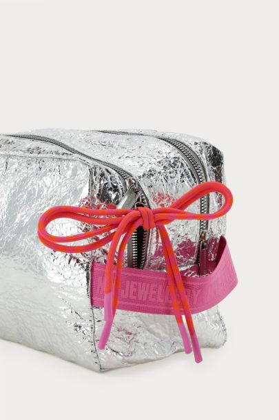Silver-coloured toiletry bag with pink bow