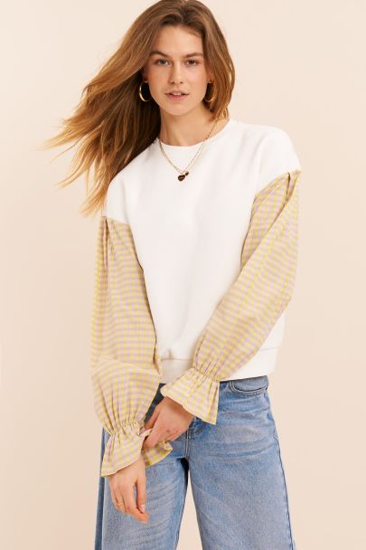 White sweater with yellow checkered sleeves