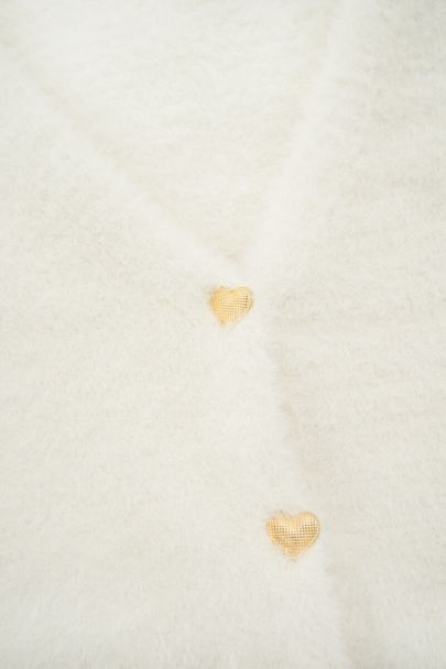 Wit vest met goudkleurige hartjes knopen