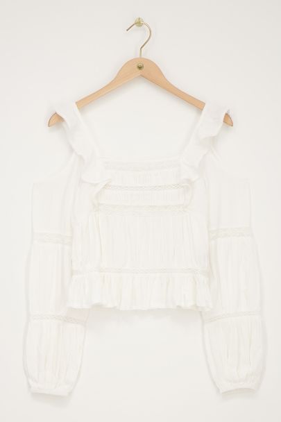 White top with long sleeves and ruffles
