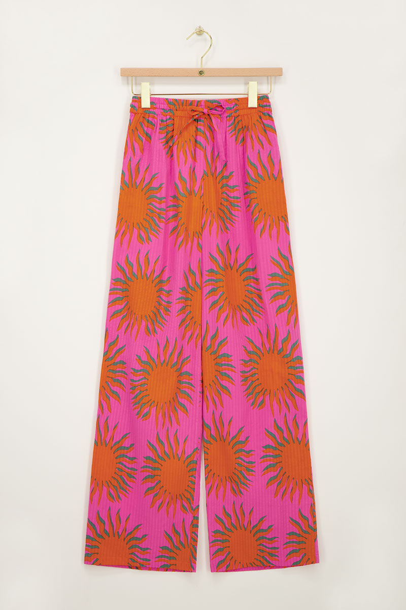 Pink wide leg trousers with sun print | My Jewellery