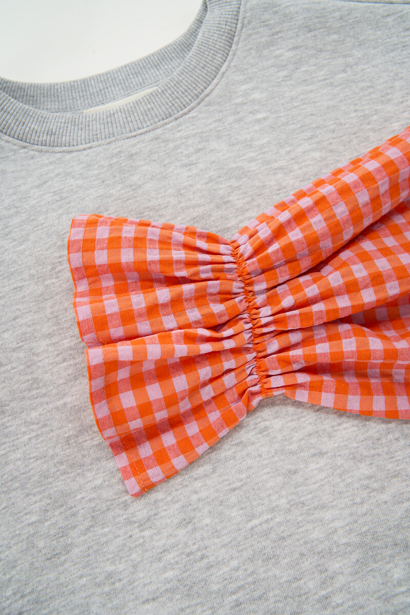 Grey sweater with orange checkered sleeves | My Jewellery