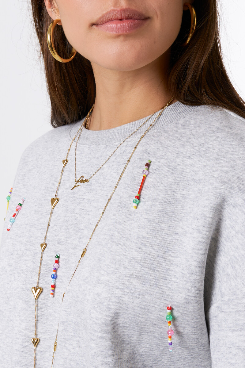 Light grey sweater with coloured beaded fringes | My Jewellery