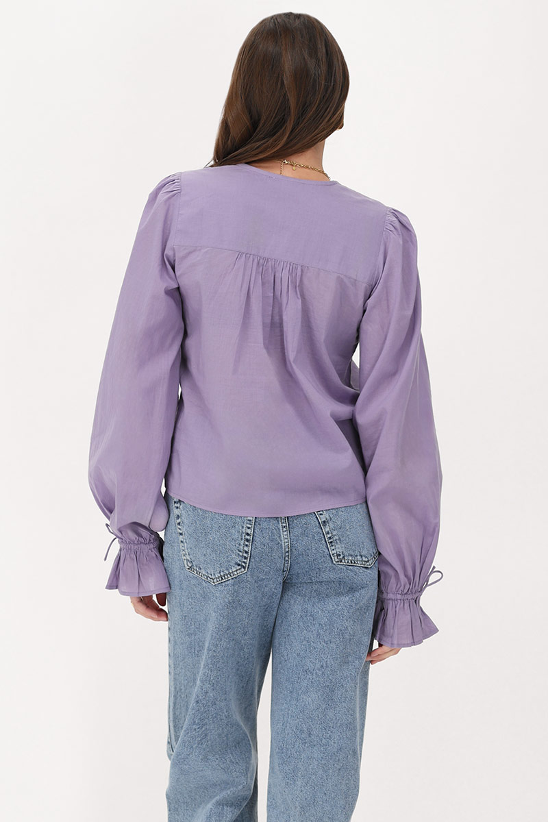 Purple blouse with ruffles and bows