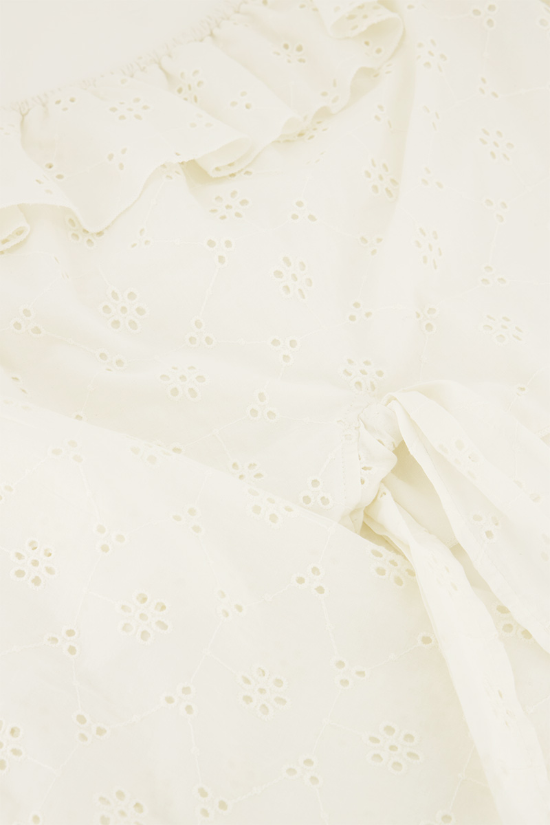 White off-shoulder top with embroidery and bow detail